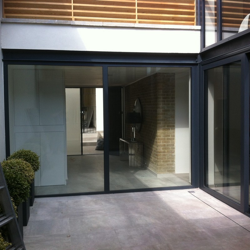 Floor-to-ceiling sliding doors opening to courtyard in Didcot